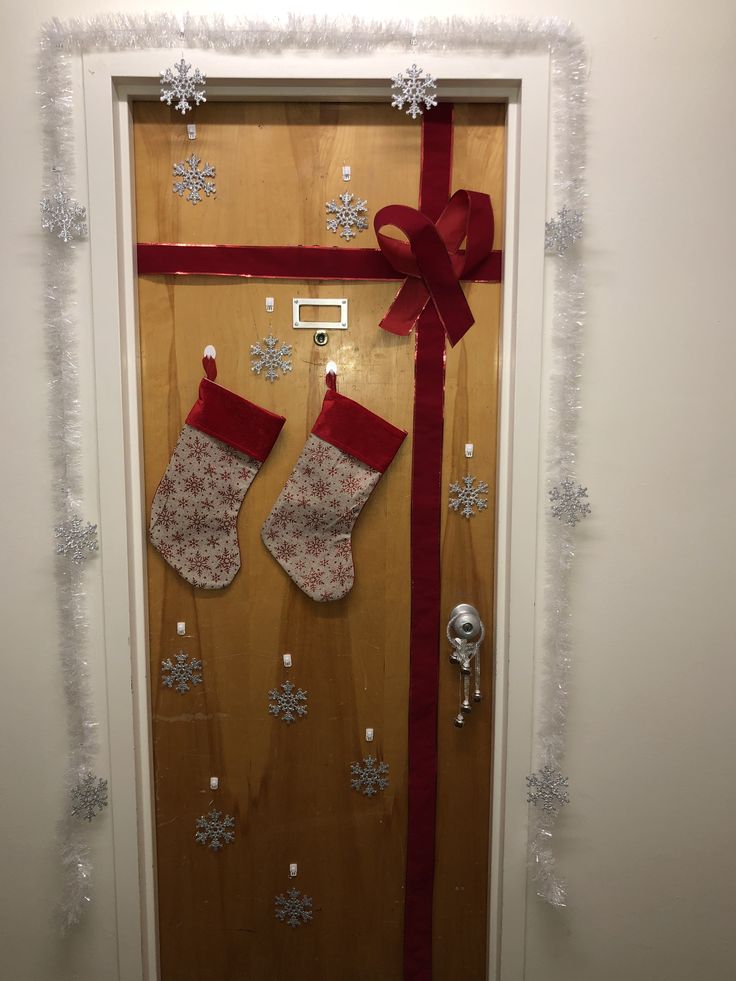 a door decorated with christmas stockings and snowflakes