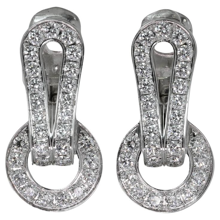 These gorgeous Cartier earrings from the classic Agrafe collection is crafted in 18k white gold and set with about 52 brilliant-cut round diamonds. Made in France circa 2000s. Measurements: 0.43" (11mm) width, 0.82" (21mm) length. Cartier Earrings, White Gold Earrings, Earrings Silver, Diamond White, Cartier, Made In France, Round Diamonds, Gold Earrings, Jewelry Earrings