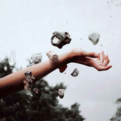 a person's arm is covered in ice and small pieces of rock falling from the sky