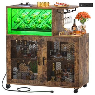 a wooden cabinet filled with lots of bottles and glasses on top of it's sides