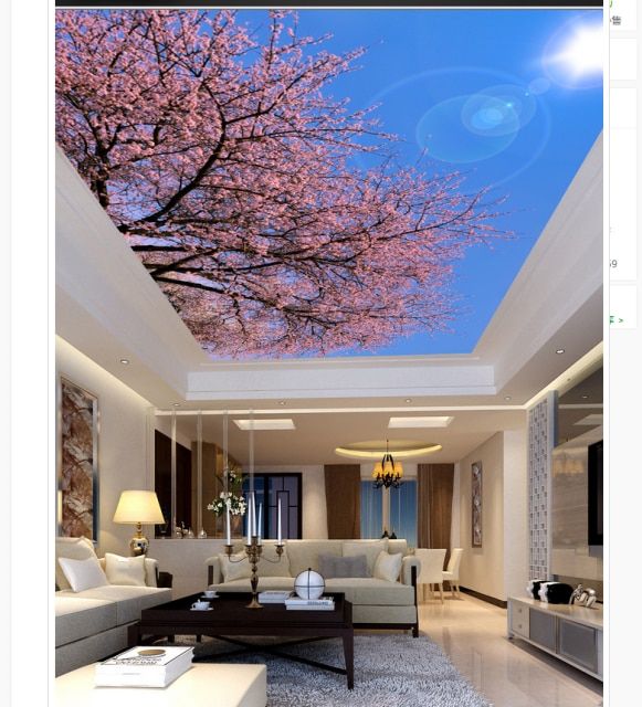 a living room filled with furniture and a pink tree in the middle of the ceiling