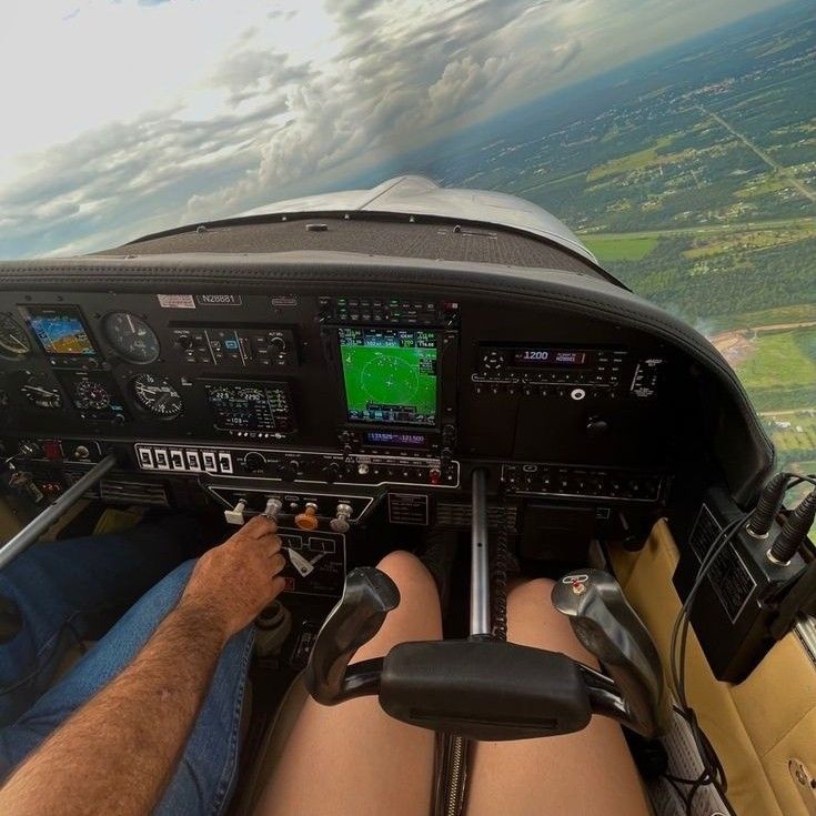 a man is sitting in the cockpit of an airplane and looking at the view from inside