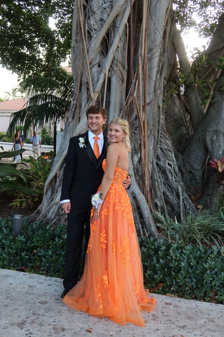 prom, prom picture inspo, orange dress, orange prom dress,orange matching tie, florida, prom in florida, jovani gowns, jovani prom, floral dress, unique prom dress, orange prom, flowy prom dress, palm trees, boyfriend,date,couple,teenagers, highschool, highschool dance, senior prom, junior prom, tall couple, dress inspo, prom inspo, love, in love, highschool sweethearts, lake, prom picture, prom nails, nail inspo, corsage, event nails, dance nails, school dance, aesthetic pic, matching Light Orange Prom Dress, Orange Prom Couple, School Dance Aesthetic, Aesthetic Prom Dress, Matching Prom, Orange Prom Dress, Flowy Prom Dresses, Hoco 2024, Jovani Gown