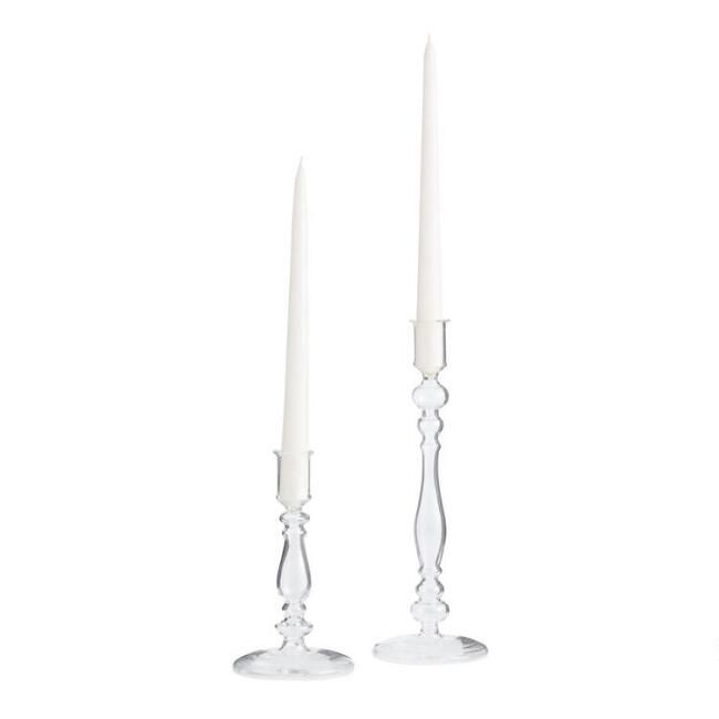 two white candles sitting next to each other