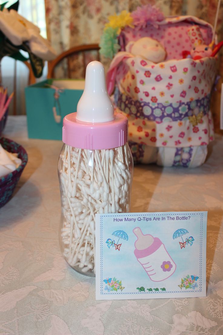 a baby bottle sitting on top of a table next to a card and other items