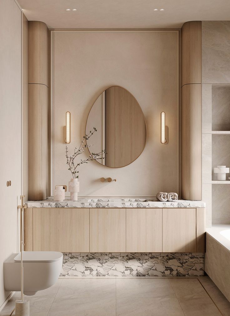 a bathroom with marble counter tops and a round mirror