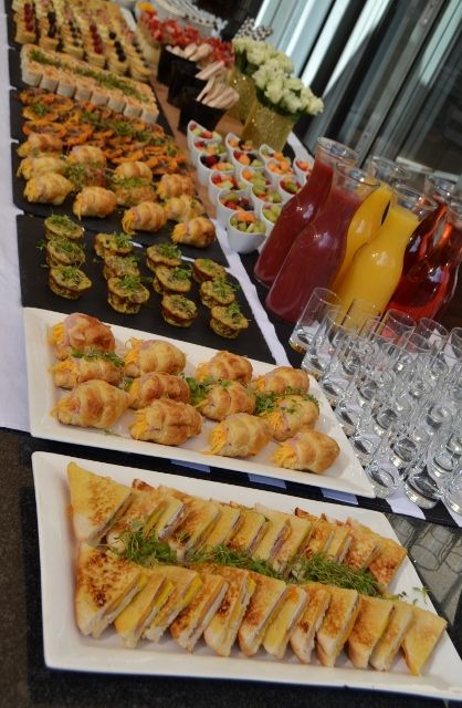 a buffet table filled with lots of different types of food and drinks on it's sides