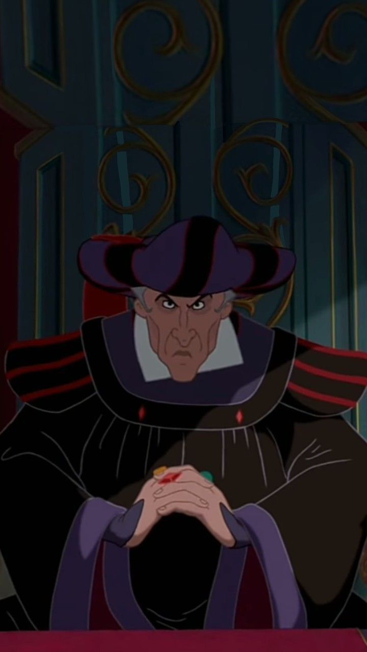 an animated image of a man in a black outfit and hat sitting at a table