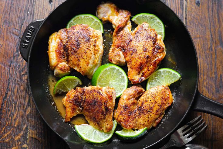 chicken with limes and cilantro in a pan