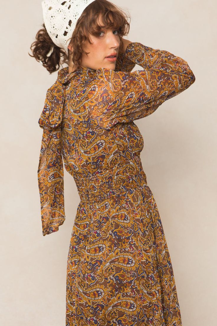 Looking for your next occasion dress? Well you've found her! Introducing the Payton Dress in Paisley! Featuring non-stretch fabric, a maxi-length skirt, smocked cuff long sleeves, high neckline and gorgeous paisley print. This women's dress is classy and timeless. You'll be reaching for it this season and beyond. Elegant Long Sleeve Maxi Dress With Smocked Back, Fitted Long Sleeve Maxi Dress With Smocked Back, Elegant Fall Maxi Dress With Smocked Cuffs, Fitted Maxi Dress With Blouson Sleeves, Bohemian Fitted Dress With Elastic Sleeves, Long Sleeve Dress With Smocked Back For Dress Down, Long Sleeve Dress With Smocked Back For Casual Occasions, Long Sleeve Dresses With Elastic Neckline, Chic Fall Maxi Dress With Smocked Bodice