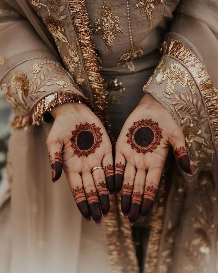 a woman's hands with hennap and rings on her fingers are shown