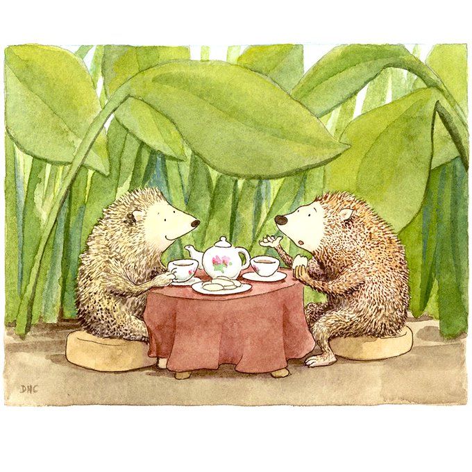 two hedges sitting at a table having tea