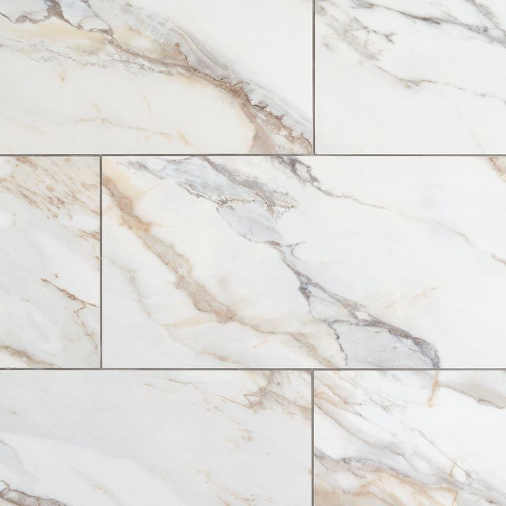 white marble tiles with grey veining on the bottom and sides, all in different sizes