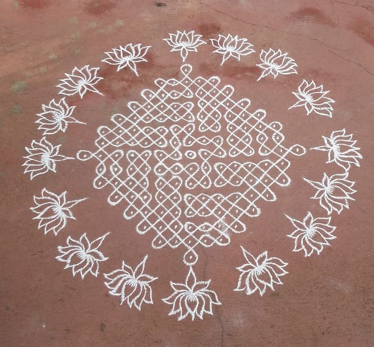 an intricate design is drawn on the ground with white chalk and markers to make it look like flowers