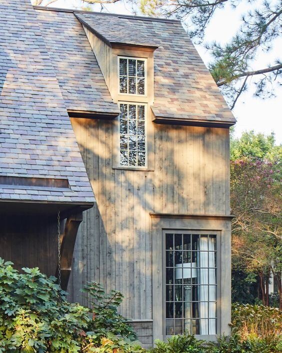 a wooden house with a large window on the side