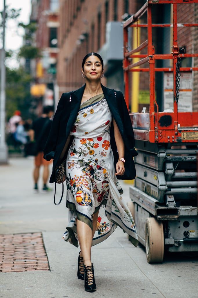 a woman is walking down the street