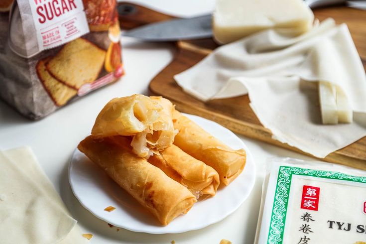 some food is on a white plate and next to a bag of sugar cubes