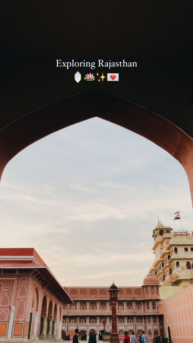 people walking under an arch in the middle of a building