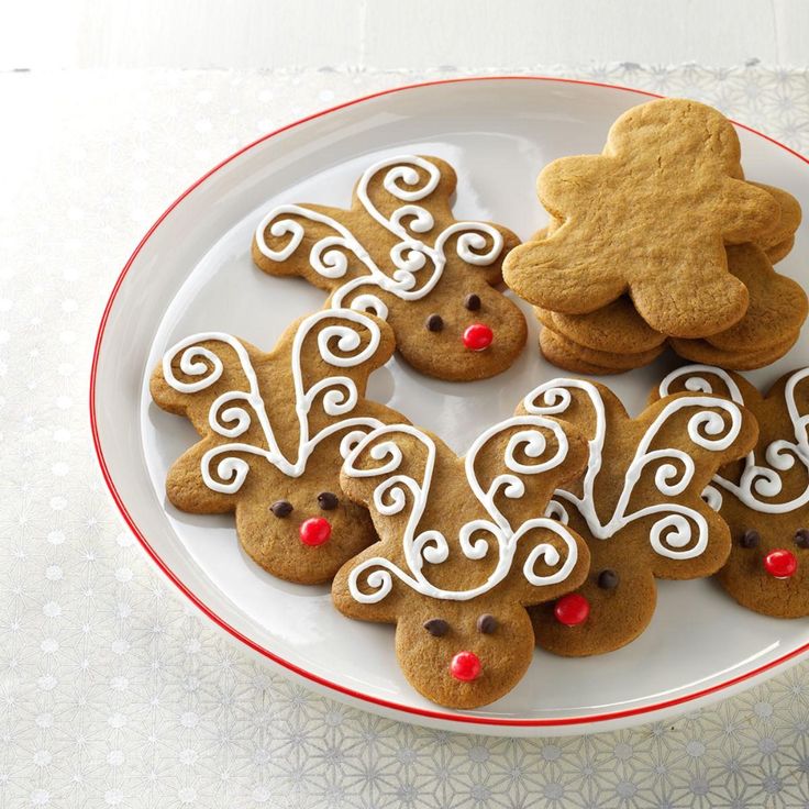 a plate full of cookies decorated with icing