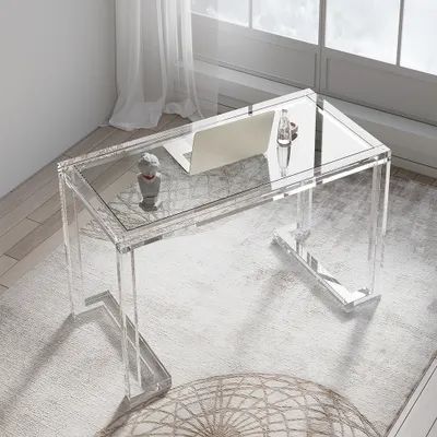 a clear desk with a laptop on it in front of a window and a rug