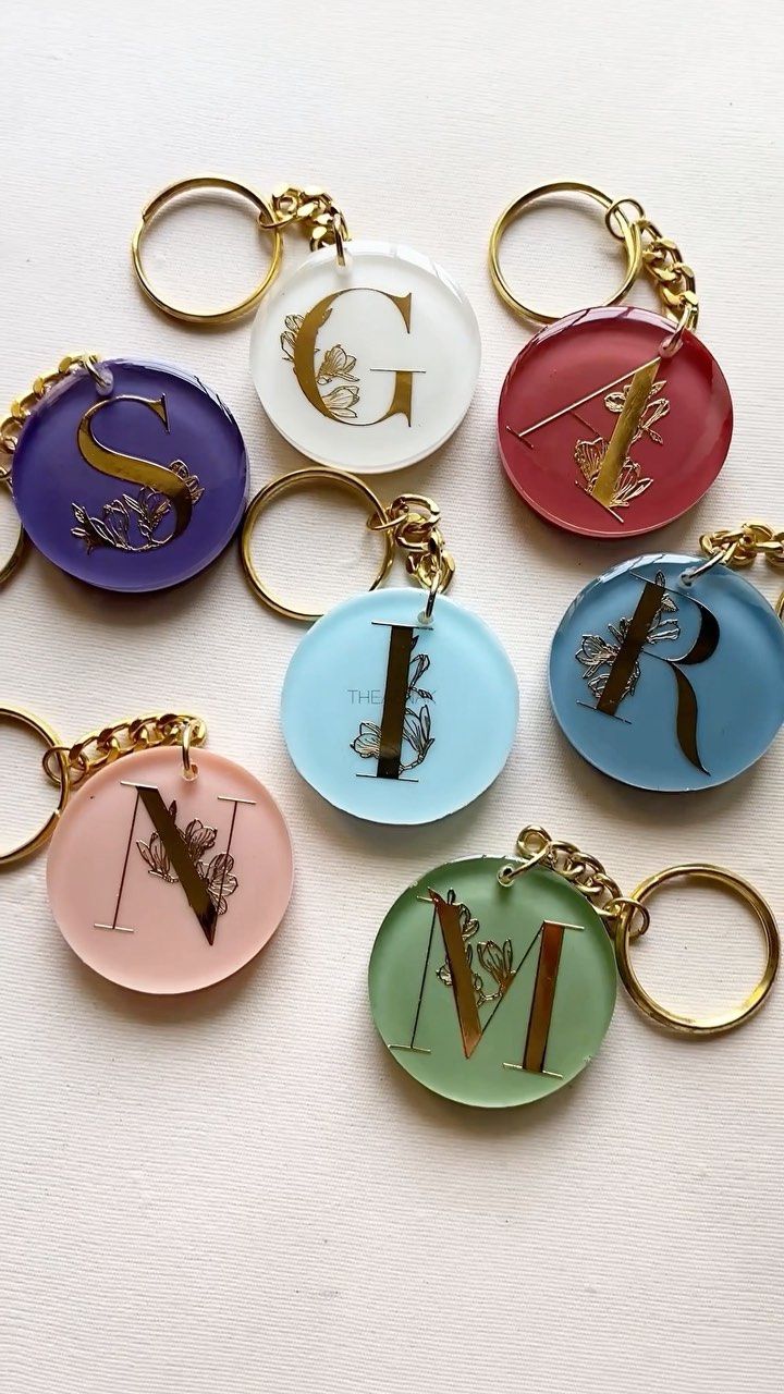 six different colored key chains with the letter v on them