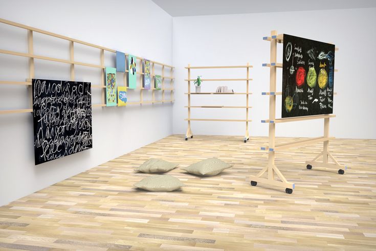 an empty room with two chalkboards and rocks on the floor