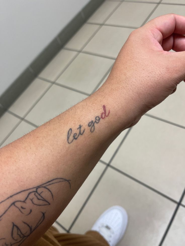 a person with a tattoo on their arm that says let god rest and be glad