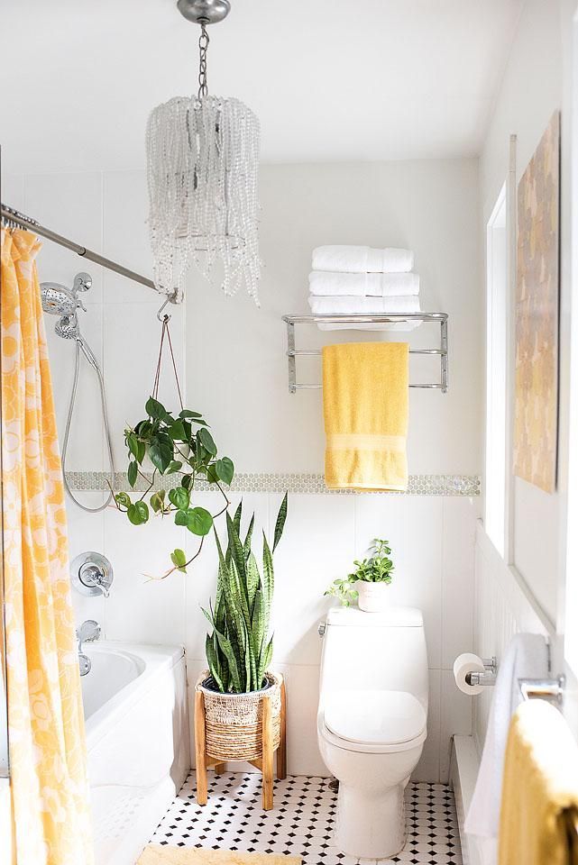 a bathroom with a toilet, shower and plants in it