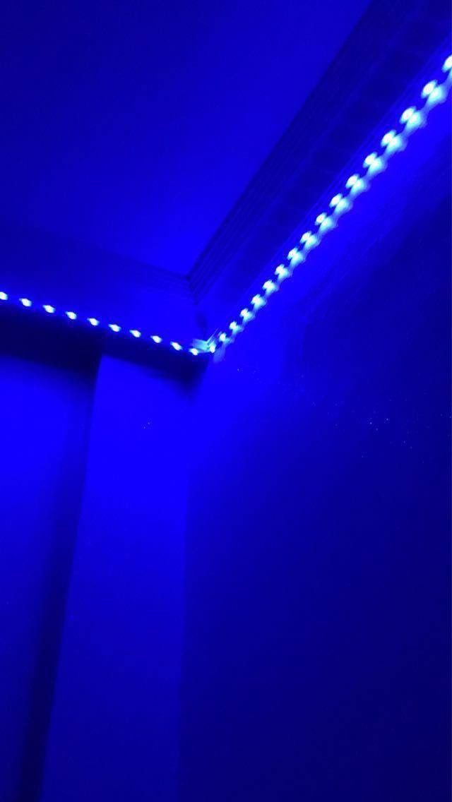 a bathroom with blue lights on the ceiling