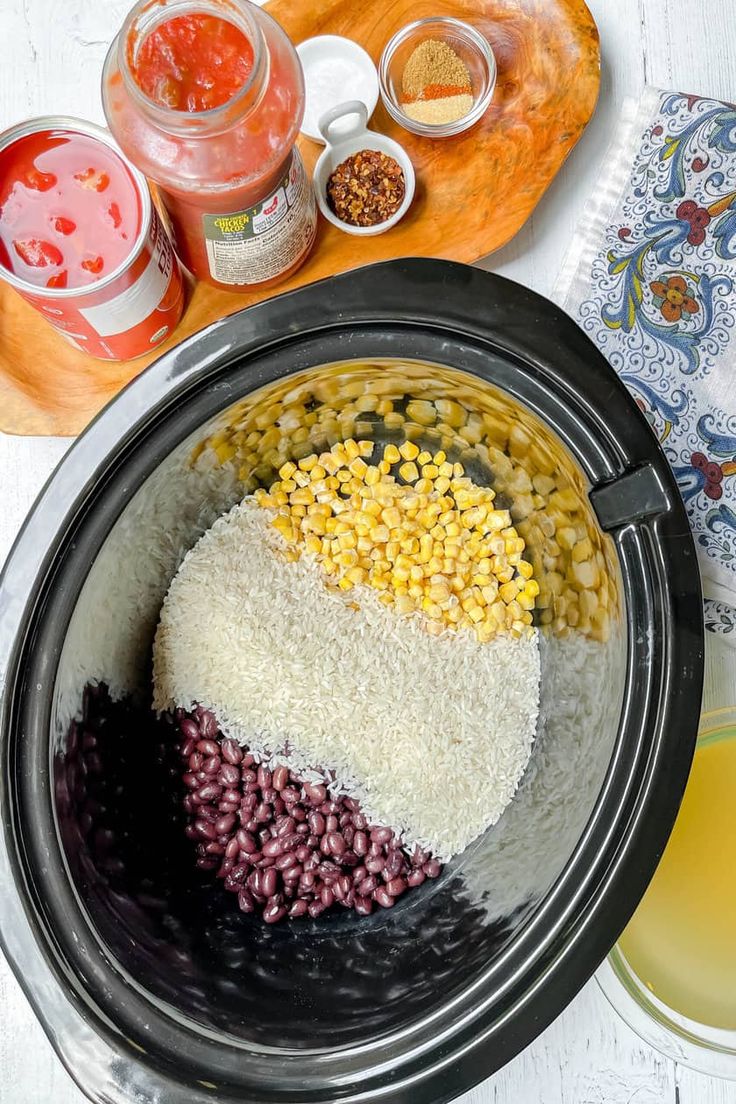 an image of food in the crock pot with corn and other ingredients around it