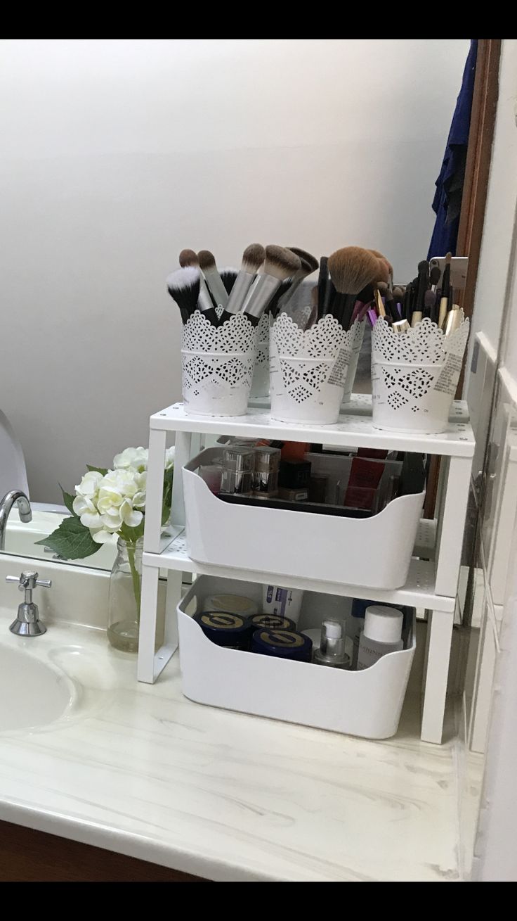 the bathroom is decorated in white with lots of beauty products