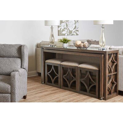 a living room scene with focus on the console table and two chairs in the background