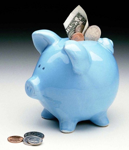 a blue piggy bank with money sticking out of it