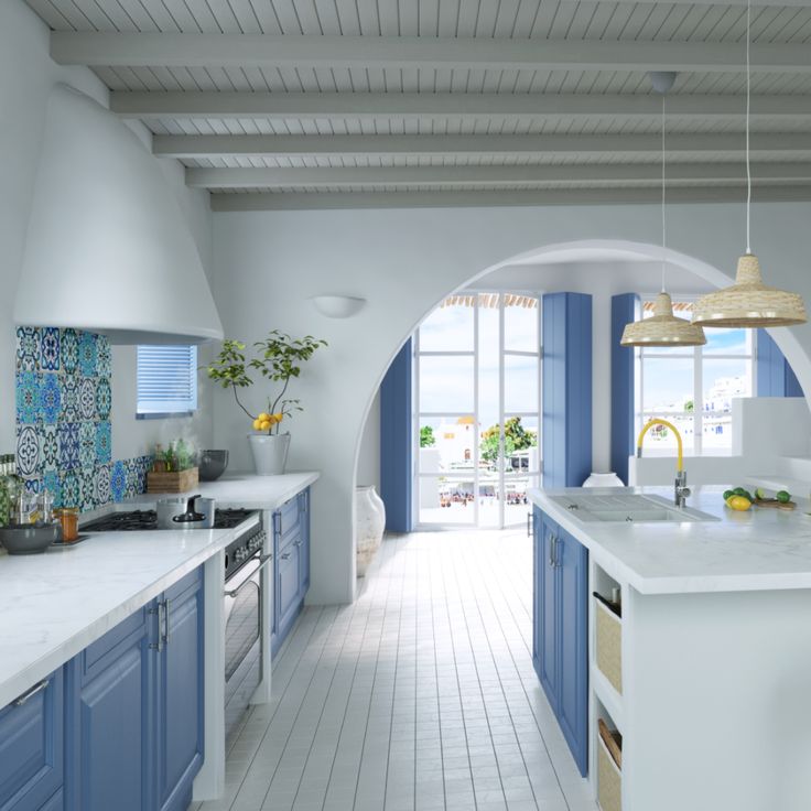 a large kitchen with blue and white cabinets, counter tops and stools in it