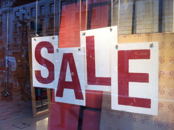 a sale sign in the window of a store