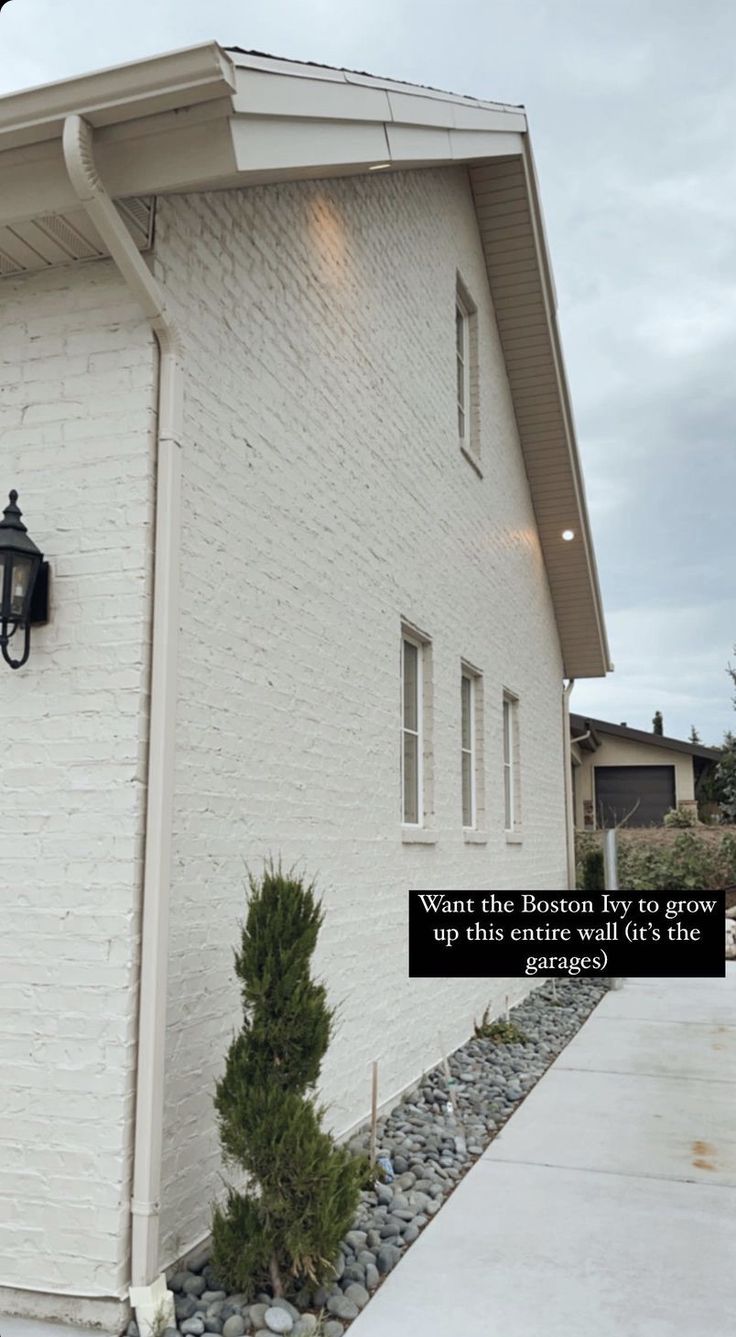 a white brick building with a light on the side