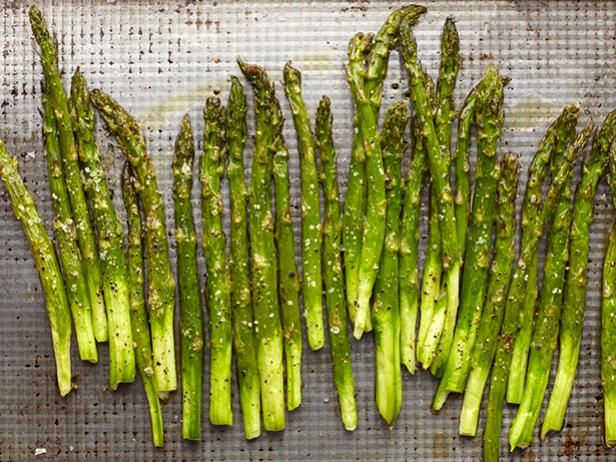 asparagus on a baking sheet ready to be cooked in the oven for dinner