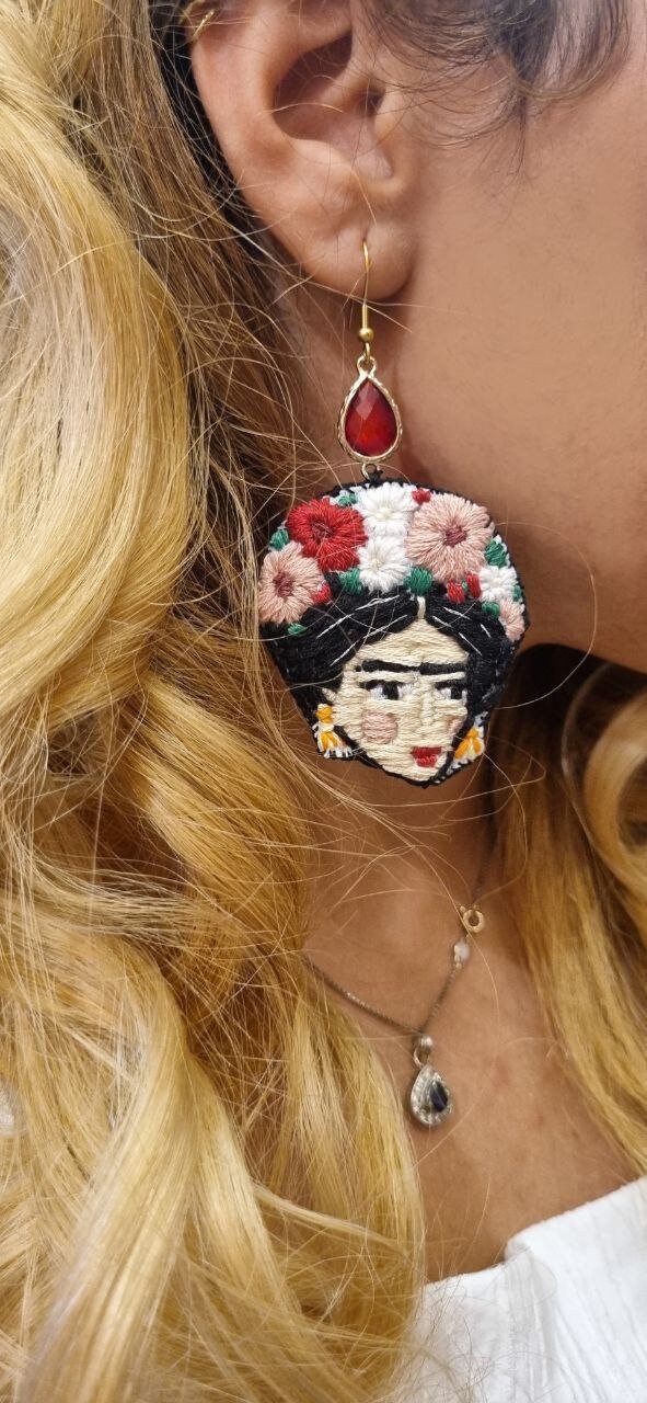 a close up of a person wearing some kind of earrings