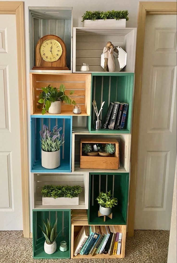 a bookshelf filled with lots of different types of plants and boxes on top of it