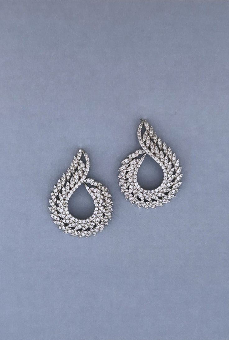 Our Stunning DAZZLIN Earrings with Swarovski Crystals and Cubic Zirconia are Absolutely Gorgeous. DAZZLIN Earrings come with Amazing Curves and can be styled with most Bridal Headpieces and will add glitter and glamour to your amazing special day. Handcrafted Highest Quality Swarovski / Cubic Zirconia Platinum plated Guards against scratches and tarnish. approximate size 1.5" length 0.5" width Nickel free Free Shipping in USA Crystals Earrings, Boutique Couture, Free Earrings, Your Amazing, Headpiece Wedding, Bridal Headband, Bridal Tiara, Tiaras And Crowns, Bridal Headpieces