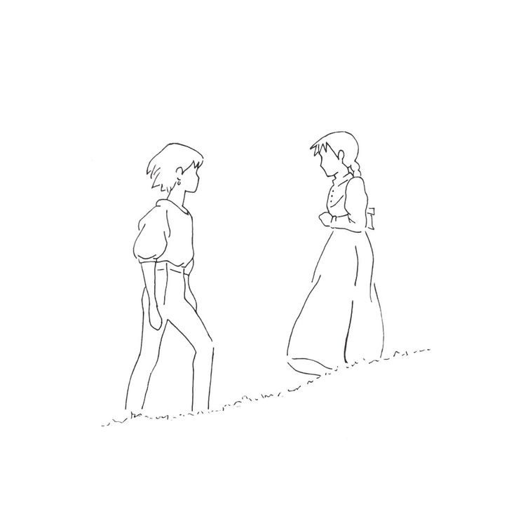 two people are standing in the grass and one is looking at another person's head