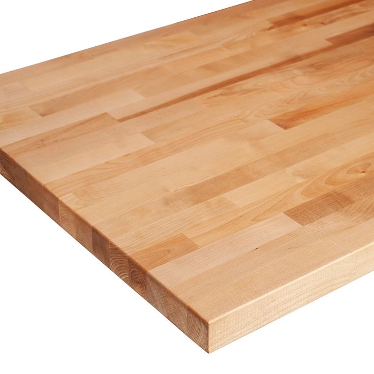 a large wooden cutting board sitting on top of a white counter tops it's surface