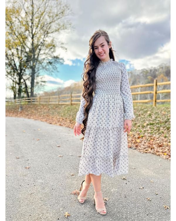 Beautiful floral print dress with stretchy smocked bodice and waistline, with ruffle detailing, tiered skirt, elastic wrists and fun tie back detail. 100% Polyester Machine wash in cold. Hang to dry. Aprox. measurements in inches: XS:Length-45.5 |Bust-28 |Waist-25 S:Length-46.5 |Bust-30 |Waist-27 M:Length-46.5 |Bust-32 |Waist-28 L:Length-47 |Bust-34 |Waist-30 XL:Length-47.5 |Bust-36 |Waist-32 modest dresses, modest dress, modest midi, modest maxi, modest fashion, modest trendy dresses, modest bo Modest Spring Dress With Smocked Back, Day Out Floral Midi Dress With Ruffles, Modest Floral Dress For Fall, Modest Flowy Floral Dress With Ruffles, Modest Flowy Floral Dress For Casual Wear, Modest Flowy Floral Dress For Casual Occasions, Feminine Spring Midi Dress With Smocked Cuffs, Modest Dresses With Smocked Cuffs For Brunch, Fall Midi Dress With Ruffle Hem For Garden Party