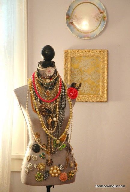 a mannequin is adorned with many different necklaces and jewelry, including an ornament