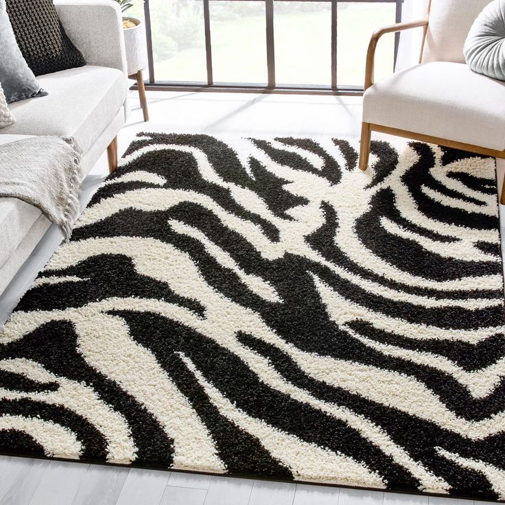 a black and white rug with zebra print on it in a living room next to a couch