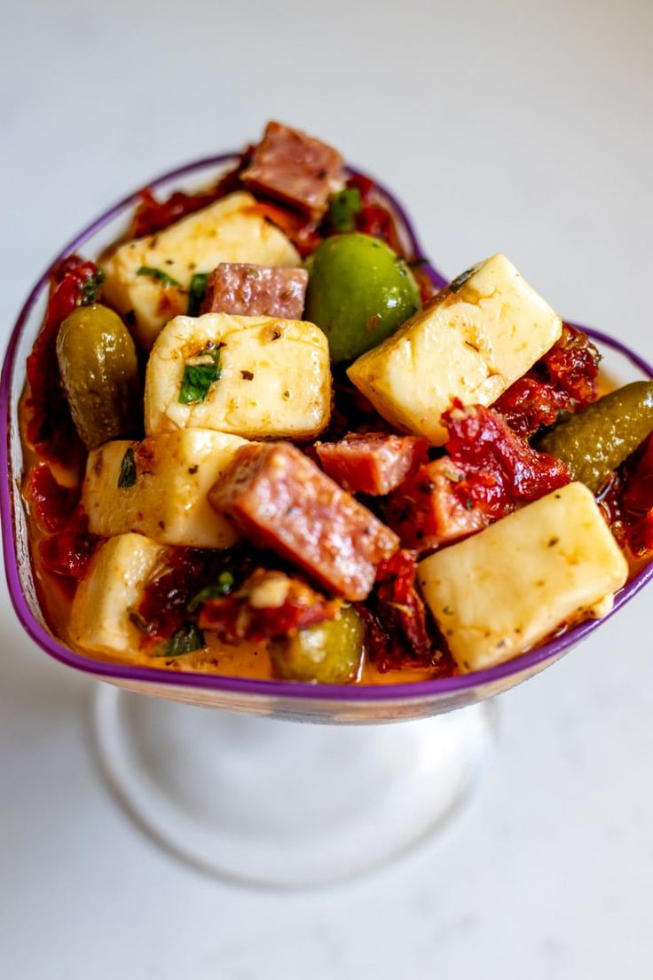 a bowl filled with lots of food on top of a table