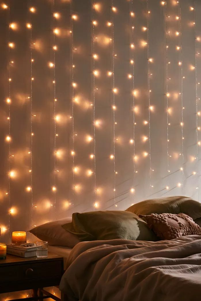 there is a bed with lights on the wall