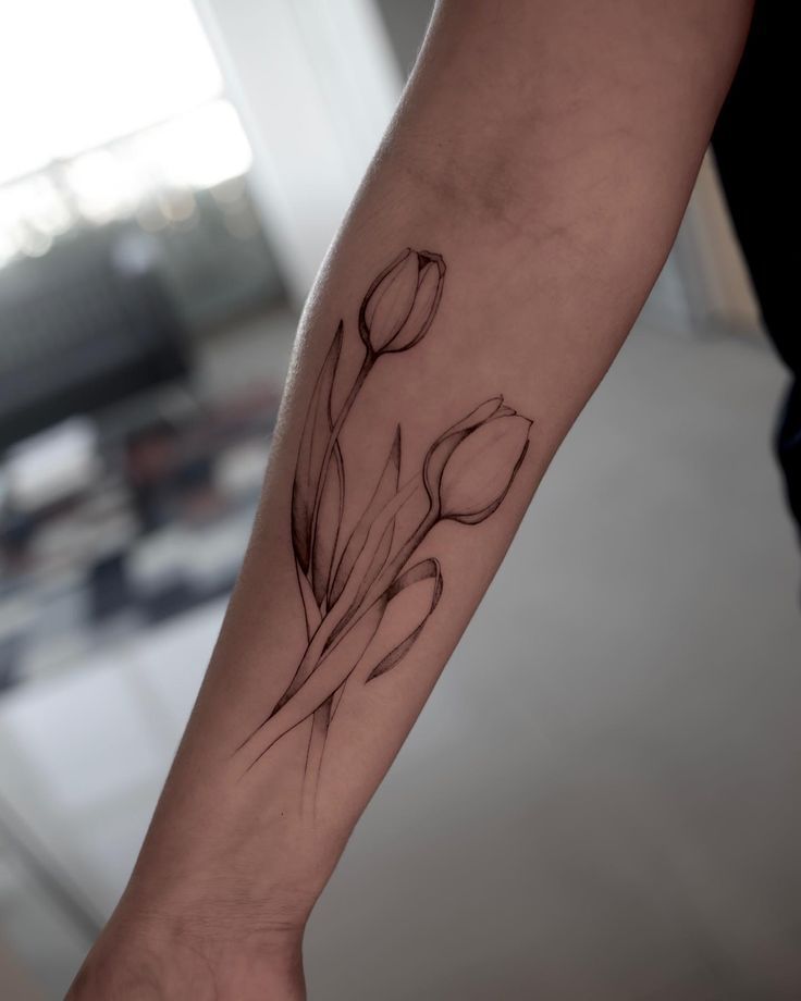 a person with a flower tattoo on their arm