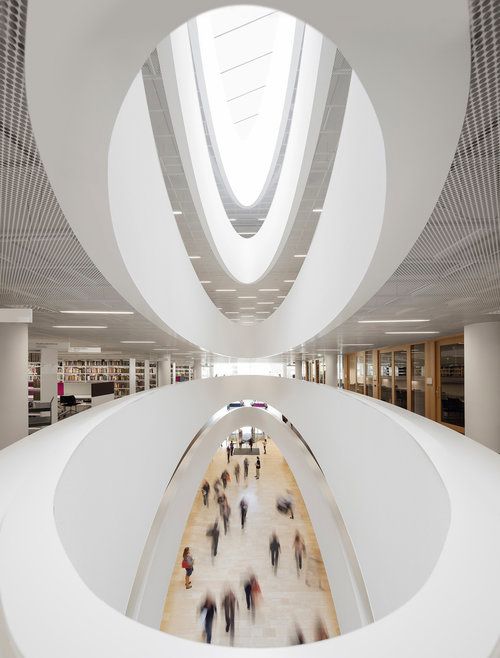 the interior of a building with people walking around