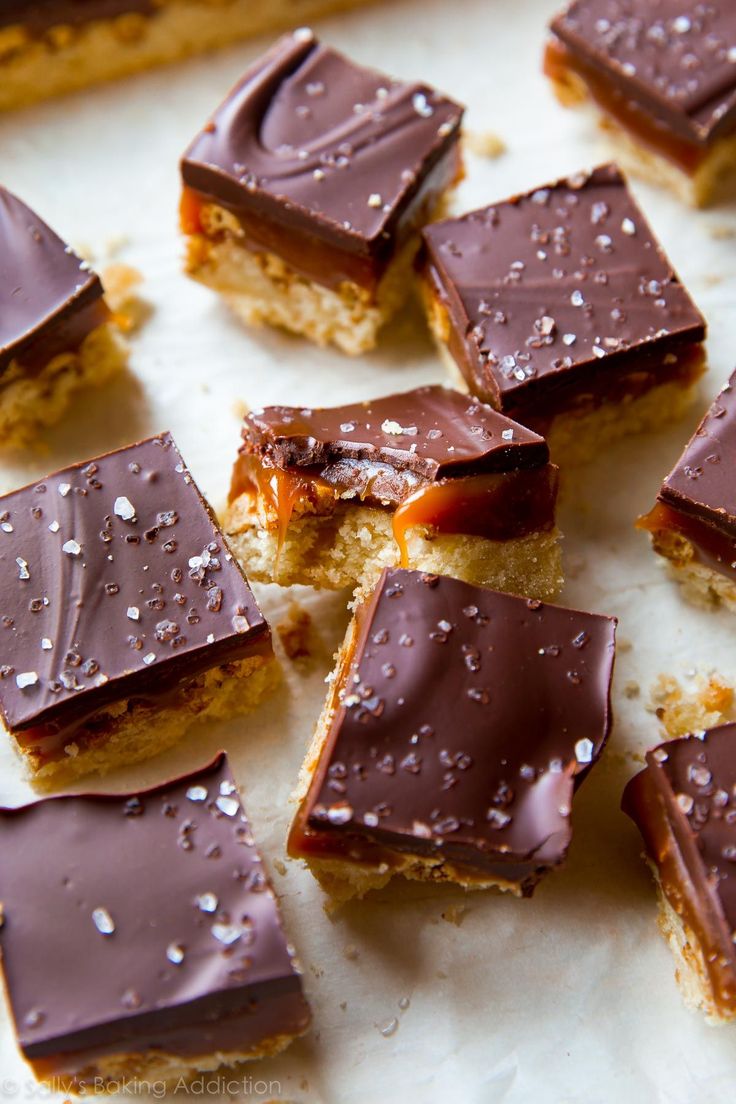 several pieces of chocolate covered dessert sitting on top of each other